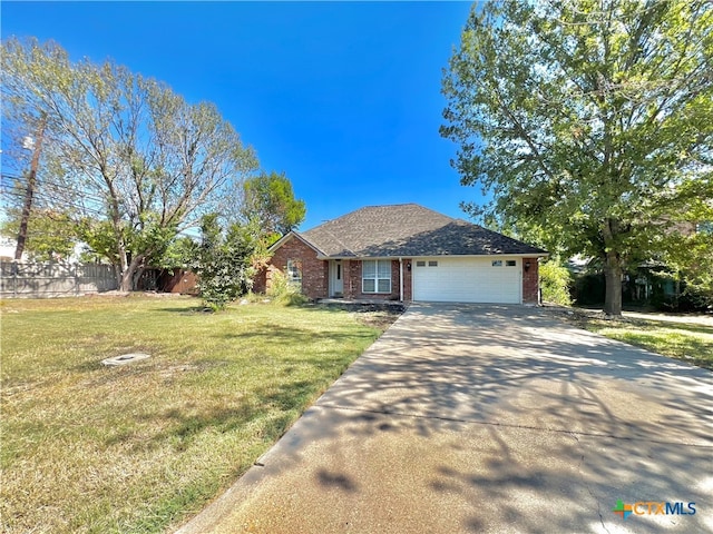 view of front of house with a garage and a front yard