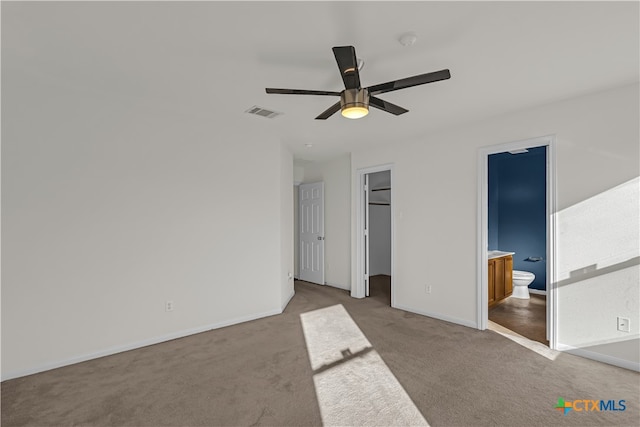 unfurnished bedroom featuring connected bathroom, ceiling fan, and carpet floors