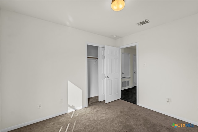 unfurnished bedroom featuring a closet and carpet floors