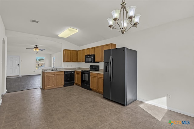 kitchen featuring black appliances, kitchen peninsula, pendant lighting, sink, and lofted ceiling