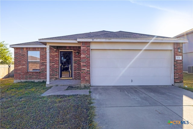 ranch-style house with a garage, cooling unit, and a front yard