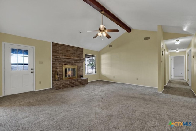 unfurnished living room with a wealth of natural light, light carpet, vaulted ceiling with beams, ceiling fan, and a brick fireplace