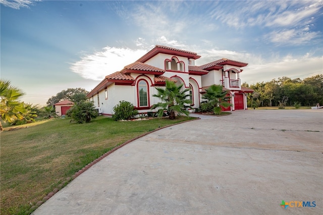 mediterranean / spanish-style home with a garage and a front yard