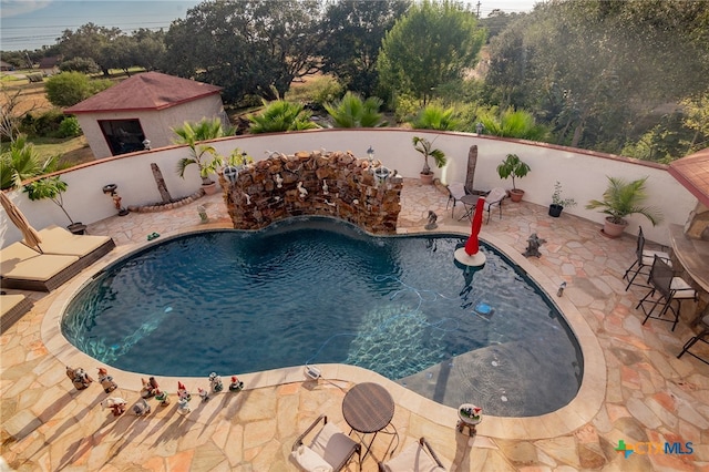 view of pool featuring a patio