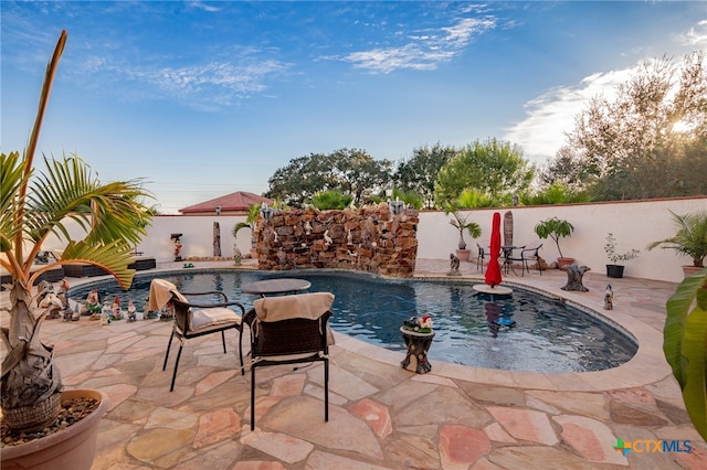 view of swimming pool featuring a patio area