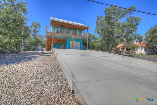 contemporary house featuring a garage and a balcony