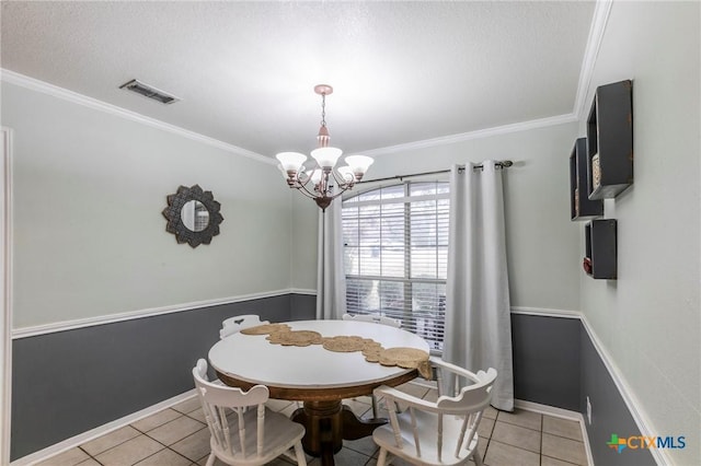 dining space featuring a notable chandelier, light tile patterned floors, and ornamental molding