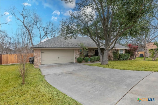 ranch-style home with a garage and a front yard