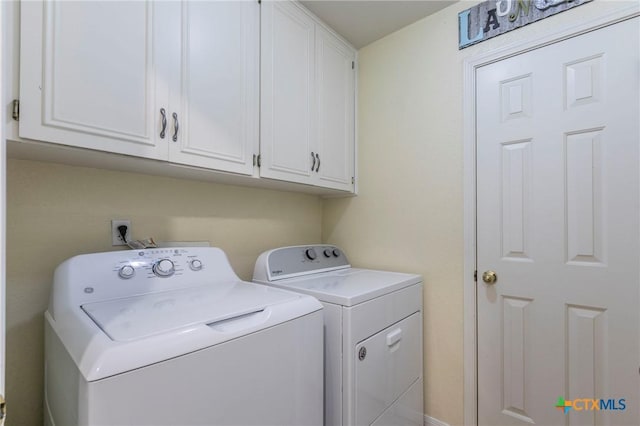 laundry room featuring cabinets and independent washer and dryer