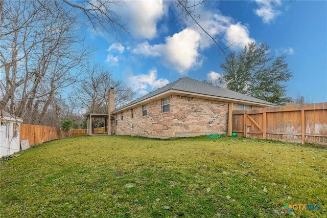 rear view of property with a lawn