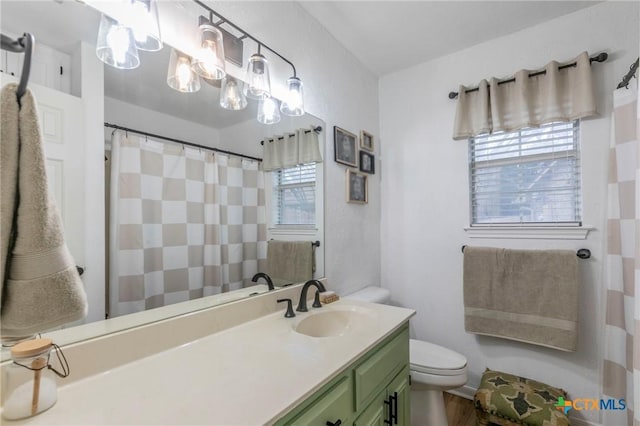 bathroom featuring vanity and toilet