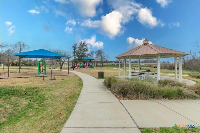 view of property's community featuring a playground, a gazebo, and a lawn