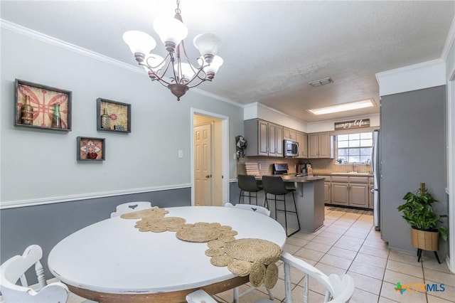 tiled dining space with crown molding and a chandelier