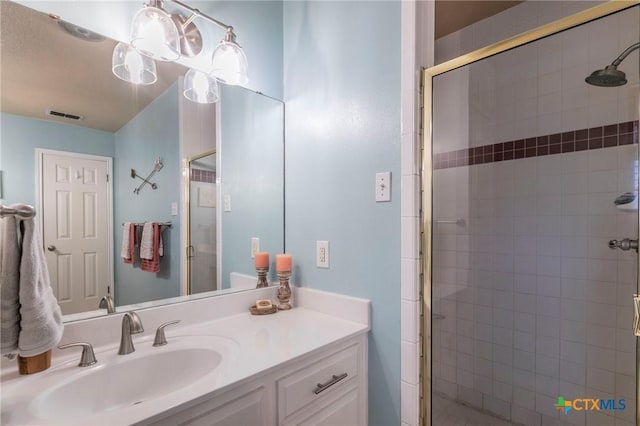 bathroom featuring vanity and an enclosed shower