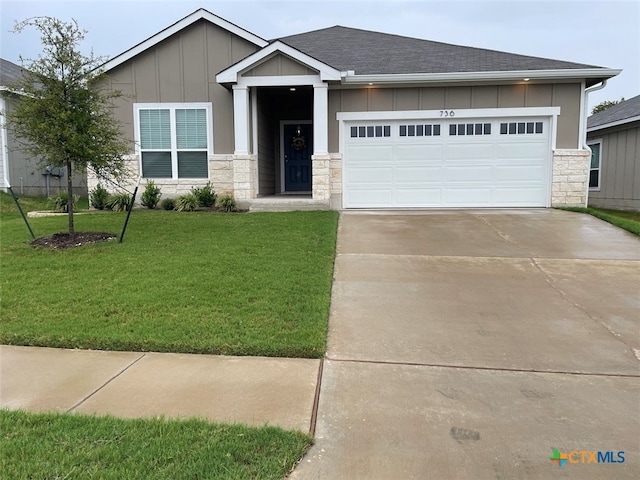 view of front of home featuring a garage and a front lawn