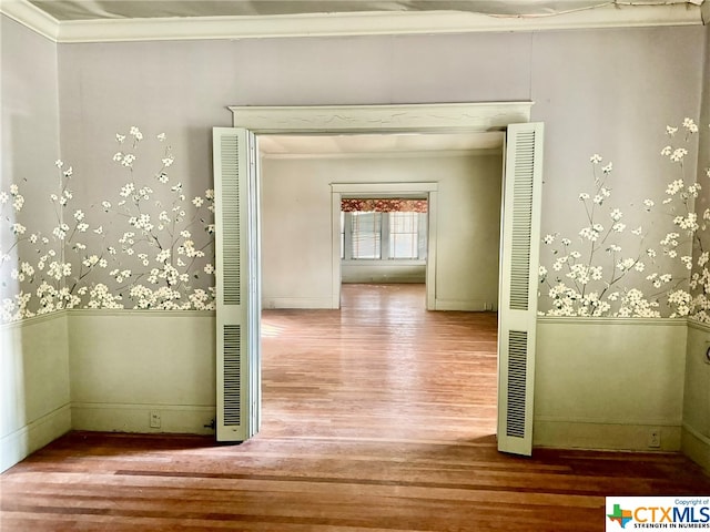 corridor with ornamental molding and wood-type flooring