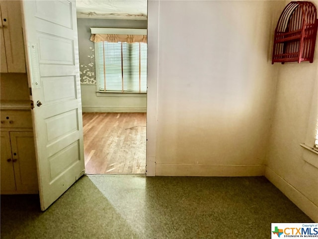 unfurnished room with hardwood / wood-style flooring