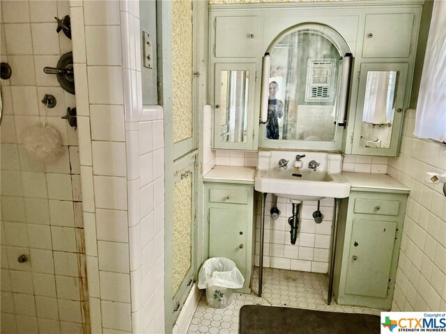 bathroom featuring backsplash, tile walls, and tile patterned floors