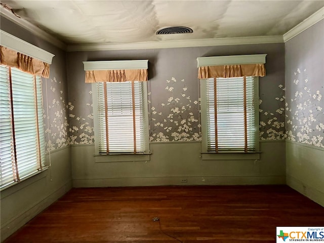 spare room with dark wood-type flooring and ornamental molding