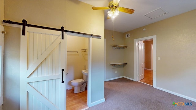 bathroom featuring toilet and ceiling fan