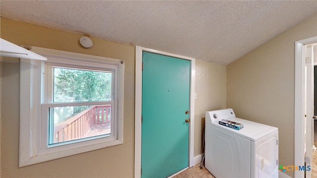 clothes washing area featuring a textured ceiling and washer / clothes dryer