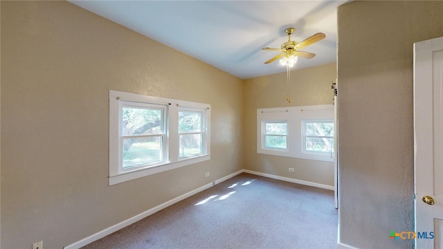 carpeted spare room with ceiling fan