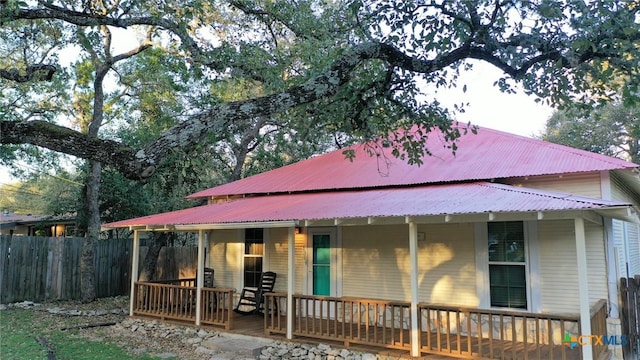 back of house featuring covered porch