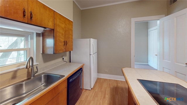 kitchen with white fridge, sink, black dishwasher, tile counters, and stovetop