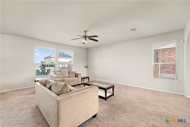 carpeted living room featuring ceiling fan