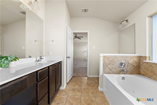 bathroom featuring vanity, lofted ceiling, tile patterned flooring, ceiling fan, and a washtub