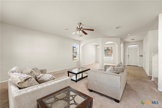 living room featuring light carpet and ceiling fan