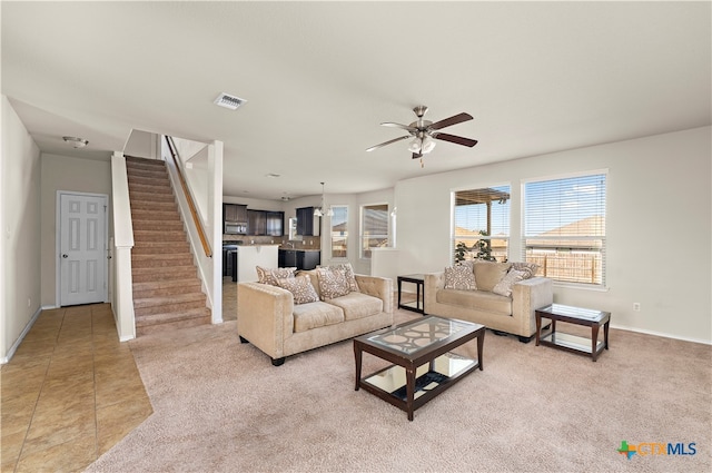 tiled living room featuring ceiling fan