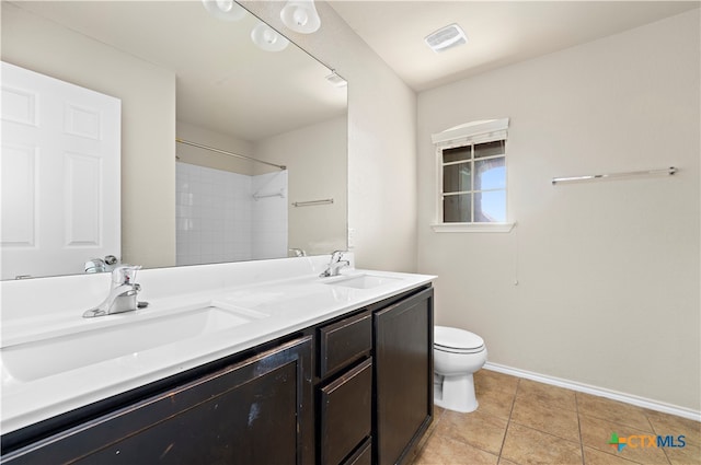 bathroom with tile patterned floors, vanity, and toilet