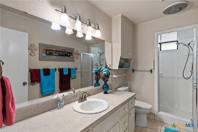 full bath with tile patterned flooring, vanity, toilet, a textured ceiling, and a shower stall
