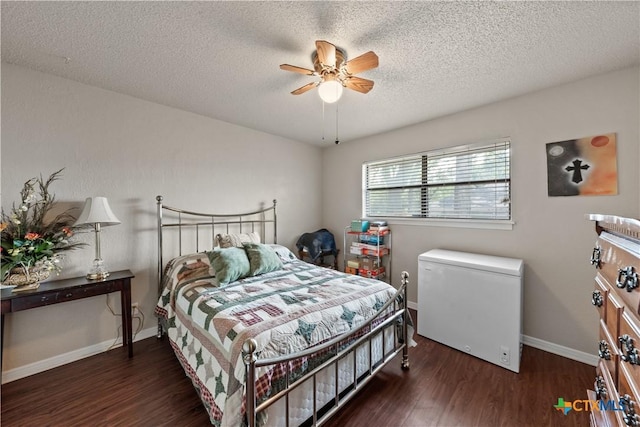 bedroom with a textured ceiling, refrigerator, and wood finished floors