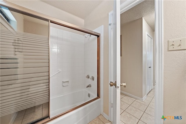 bathroom featuring baseboards, a textured ceiling, combined bath / shower with glass door, and tile patterned floors