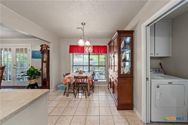 dining space with a notable chandelier, a textured ceiling, french doors, washer / clothes dryer, and visible vents