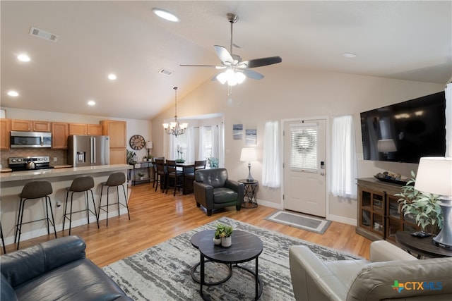 2265 Candlelight Dr, Canyon Lake, TX 78133 - living room with a ceiling fan, vaulted ceiling, a chandelier, light wood-style flooring, and recessed lighting