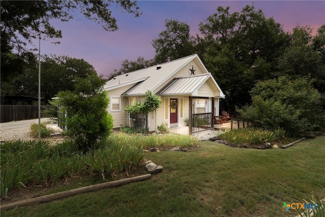 2265 Candlelight Dr, Canyon Lake, TX 78133 - view of front of home featuring a lawn, a metal roof, a porch, and a standing seam roof