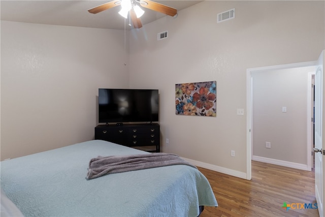 2265 Candlelight Dr, Canyon Lake, TX 78133 - bedroom featuring light wood-style flooring, ceiling fan, and a high ceiling