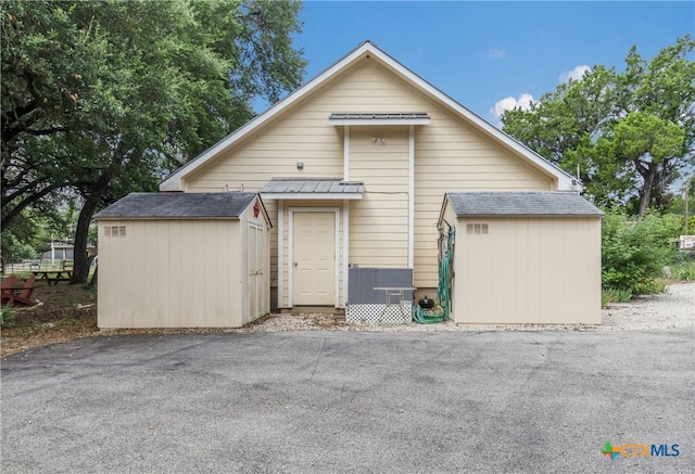 2265 Candlelight Dr, Canyon Lake, TX 78133 - view of front of house with a storage unit and roof with shingles