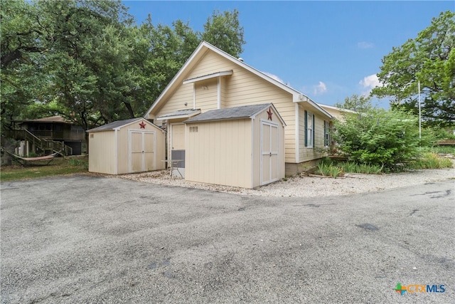 2265 Candlelight Dr, Canyon Lake, TX 78133 - view of home's exterior featuring a storage shed