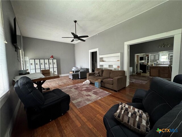 906 N Penelope St, Belton, TX 76513 - living area featuring wood finished floors, a ceiling fan, healthy amount of natural light, a textured ceiling, and a high ceiling