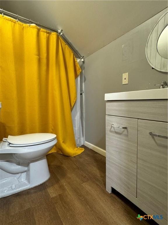 906 N Penelope St, Belton, TX 76513 - full bathroom featuring wood finished floors, vanity, toilet, and baseboards