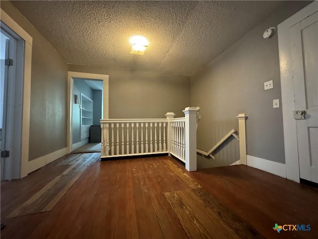 906 N Penelope St, Belton, TX 76513 - additional living space featuring hardwood / wood-style floors, a textured ceiling, and baseboards