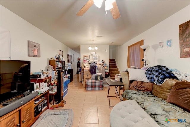 tiled living room featuring ceiling fan with notable chandelier