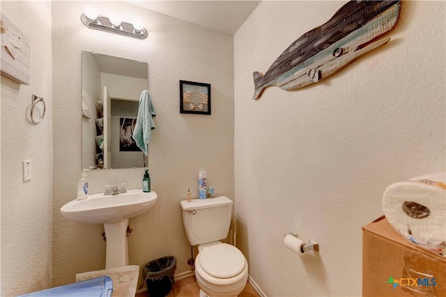 bathroom with tile patterned flooring and toilet