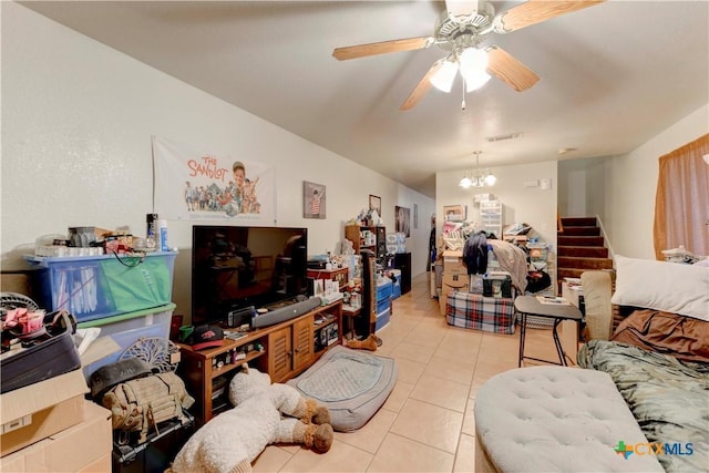 living room featuring light tile patterned floors and ceiling fan with notable chandelier