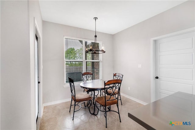 211 Amberglow Ct, Victoria, TX 77904 - dining space with baseboards and a chandelier