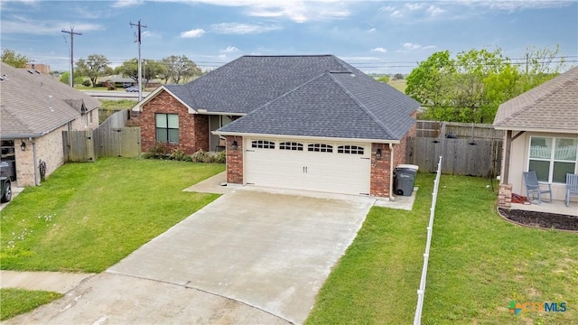 211 Amberglow Ct, Victoria, TX 77904 - view of front facade with brick siding, a gate, driveway, a shingled roof, and a garage